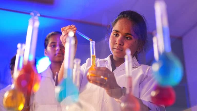 Students working with coloured liquids in a science lab